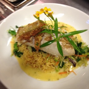 Pan seared gag grouper with yellow rice and house grown tarragon flowers